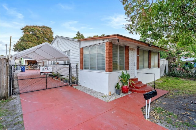 view of side of home with a carport