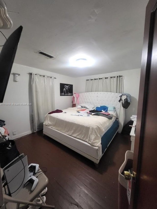 bedroom featuring dark hardwood / wood-style floors