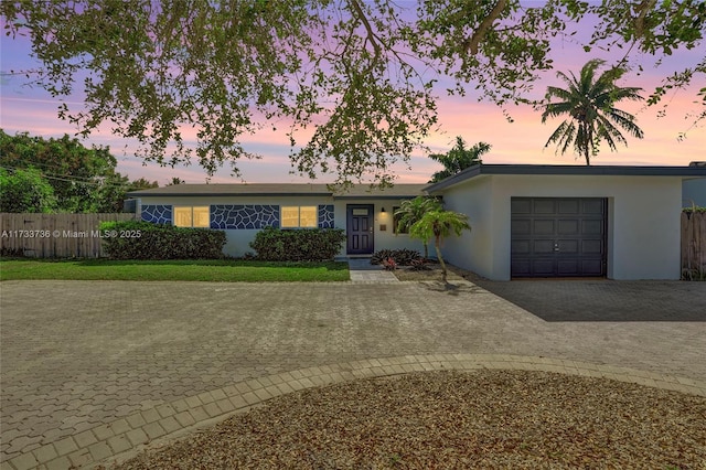 2720 SW 19th St, Fort Lauderdale, FL 33312 - ranch-style house with decorative driveway, a garage, stucco siding, and fence