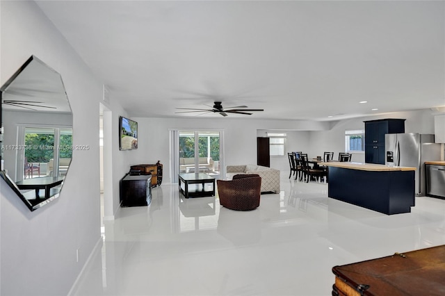 living room with plenty of natural light and ceiling fan