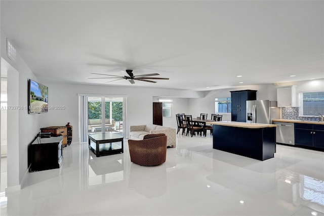 living room with sink and ceiling fan