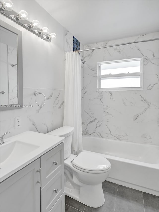 full bathroom with toilet, tile walls, vanity, shower / bath combo with shower curtain, and tile patterned flooring