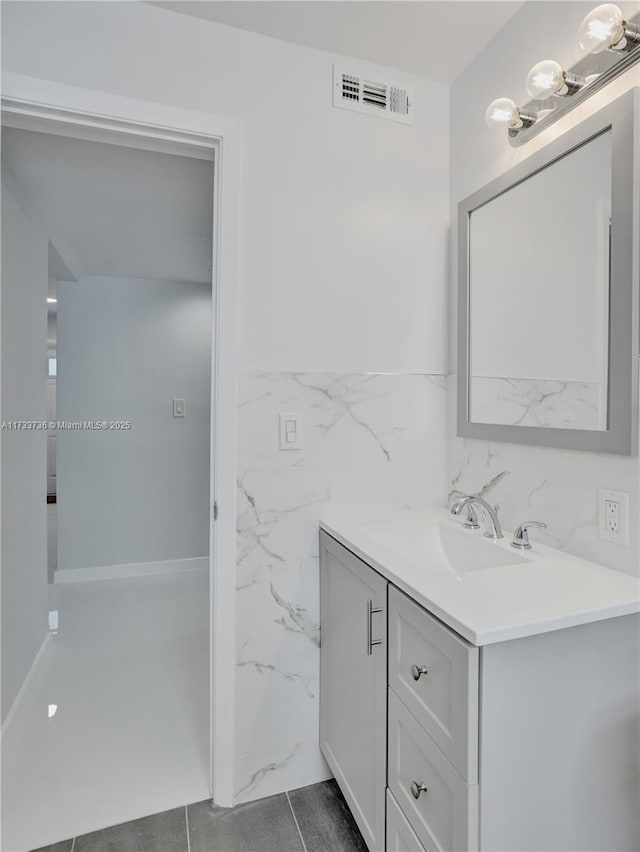 2720 SW 19th St, Fort Lauderdale, FL 33312 - bathroom featuring vanity, a wainscoted wall, and tile walls