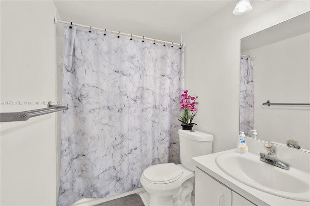 bathroom featuring tile patterned floors, vanity, and toilet