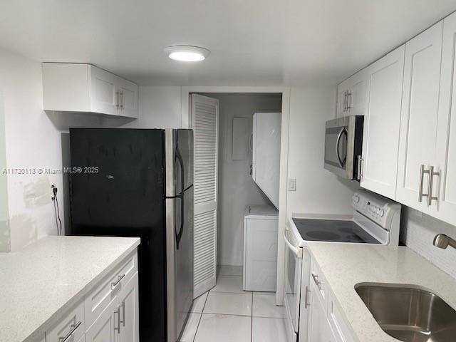 kitchen with white cabinetry, appliances with stainless steel finishes, and sink