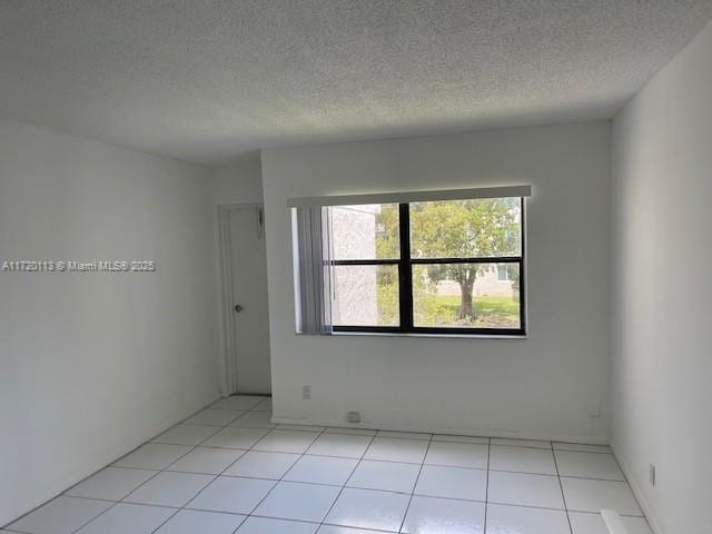 empty room featuring plenty of natural light and a textured ceiling