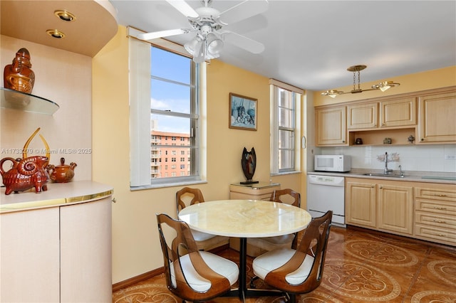 kitchen featuring white appliances, sink, decorative backsplash, and light brown cabinets