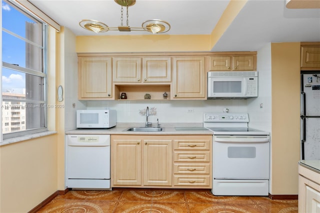 kitchen with light brown cabinetry, tasteful backsplash, sink, light tile patterned floors, and white appliances