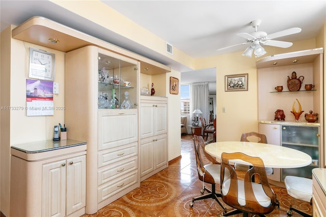 tiled dining area featuring ceiling fan