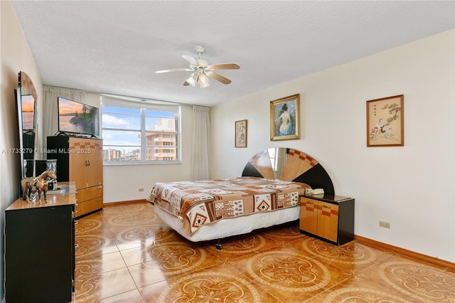 tiled bedroom featuring a textured ceiling and ceiling fan