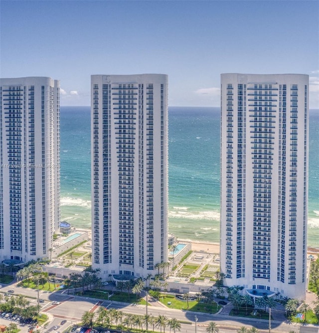 birds eye view of property with a water view and a view of the beach