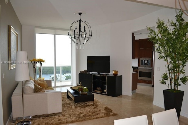 living room with a chandelier, floor to ceiling windows, and a healthy amount of sunlight