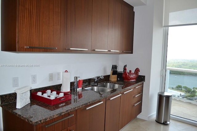 kitchen featuring sink and dark stone counters