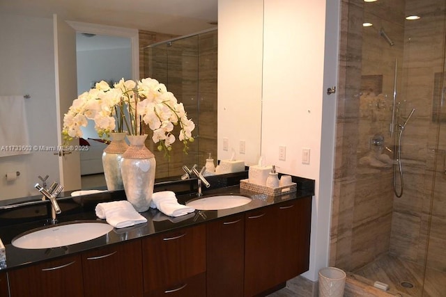 bathroom featuring vanity and a shower with shower door