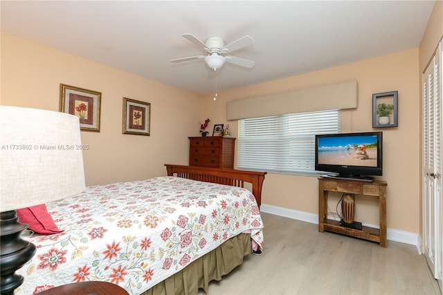 bedroom with light hardwood / wood-style flooring and ceiling fan