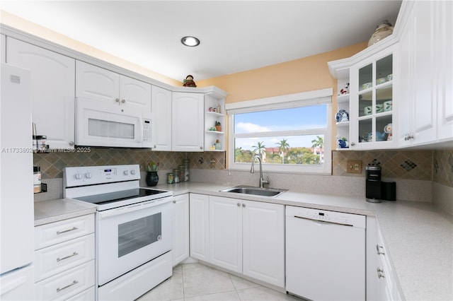 kitchen featuring white cabinetry, sink, and white appliances