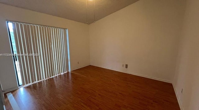 unfurnished room featuring dark hardwood / wood-style floors