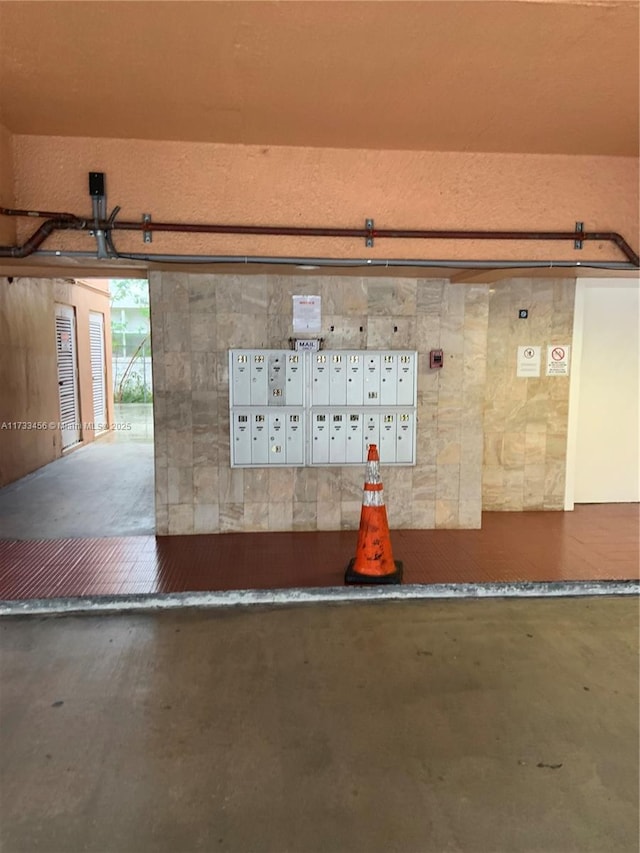 interior details with concrete flooring and a mail area