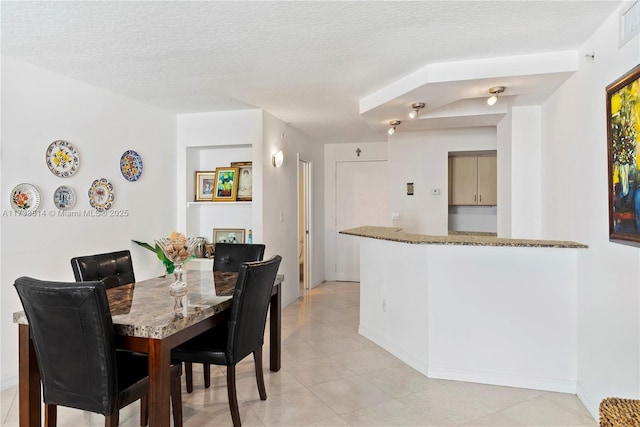 dining area with a textured ceiling