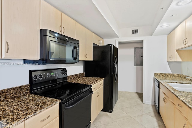 6917 Collins Ave Unit 1512, Miami Beach, FL 33141 - kitchen with dark stone countertops, visible vents, a sink, light brown cabinetry, and black appliances