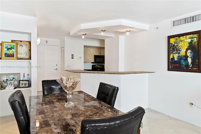 dining area with a textured ceiling