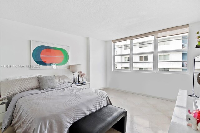 6917 Collins Ave Unit 1512, Miami Beach, FL 33141 - bedroom with a textured ceiling and baseboards