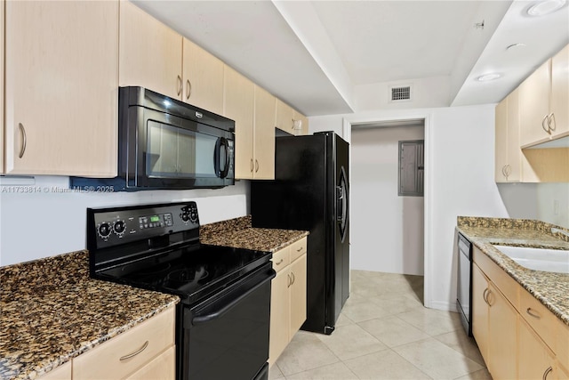 kitchen with sink, light tile patterned floors, black appliances, light brown cabinetry, and dark stone counters