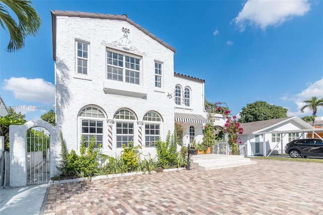 mediterranean / spanish house with a carport