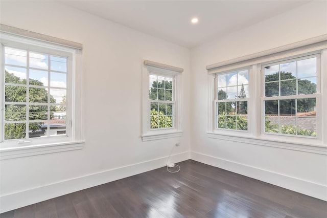 spare room featuring dark hardwood / wood-style flooring