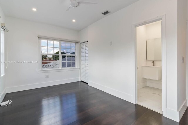 unfurnished room featuring ceiling fan, a healthy amount of sunlight, and dark hardwood / wood-style floors