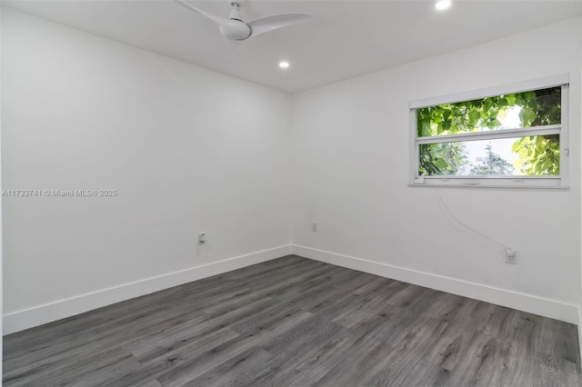 unfurnished room with ceiling fan and dark hardwood / wood-style flooring