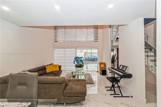 living area with marble finish floor and stairs