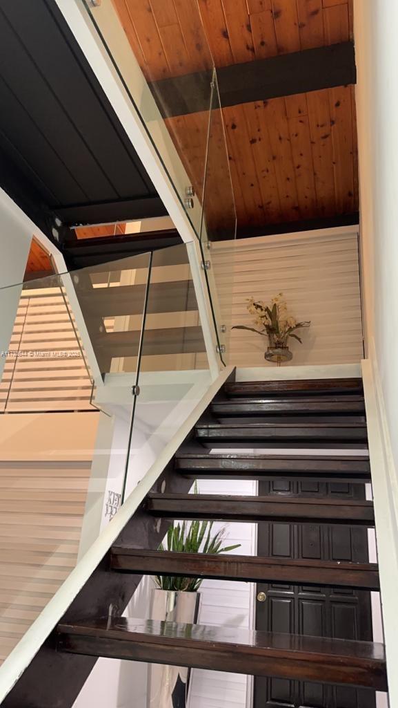 stairs with wood ceiling