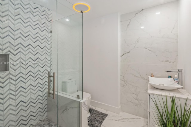 full bath with marble finish floor, a stall shower, vanity, and toilet