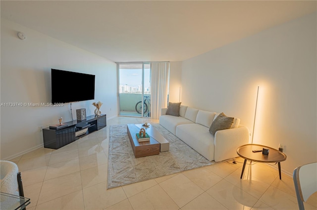 living room featuring light tile patterned floors and a wall of windows