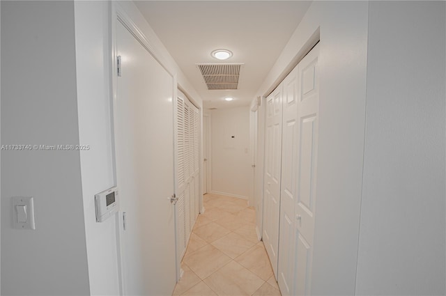 hall featuring light tile patterned floors