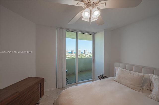 bedroom with ceiling fan, access to exterior, a wall of windows, and light tile patterned floors