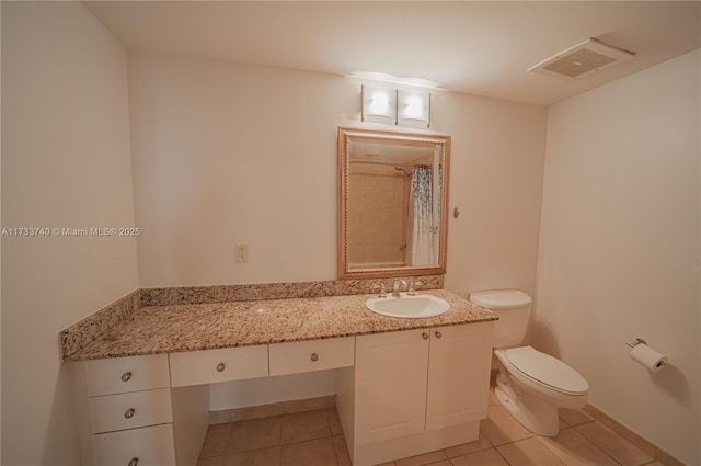 bathroom with a shower with curtain, vanity, toilet, and tile patterned flooring