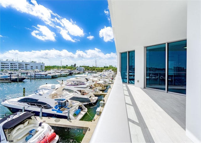 balcony with a dock and a water view