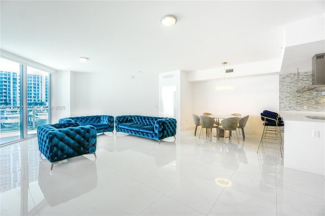 tiled living room with a wall of windows