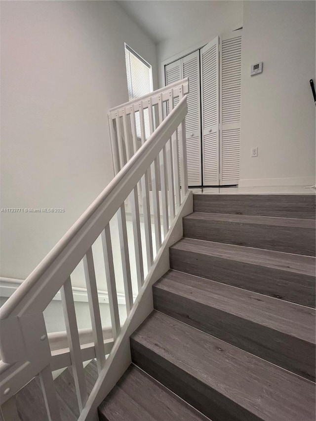 stairs featuring hardwood / wood-style flooring