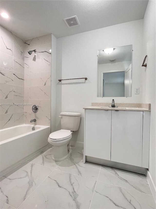 full bathroom with tiled shower / bath combo, vanity, a textured ceiling, and toilet