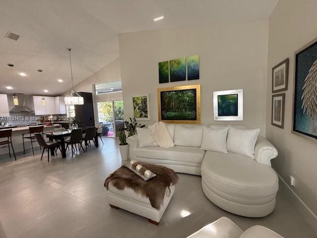 living room with high vaulted ceiling