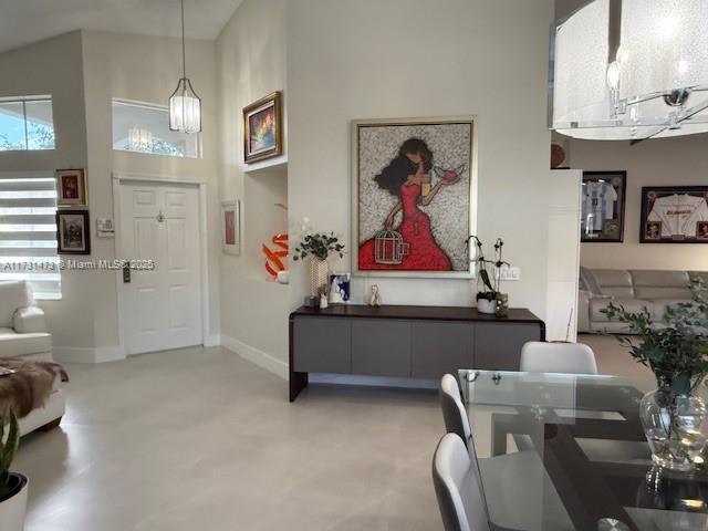 foyer with a towering ceiling and concrete flooring