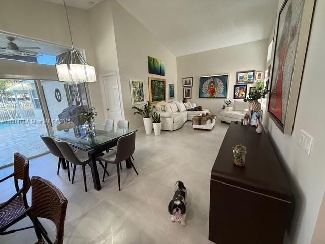 dining room featuring a chandelier and high vaulted ceiling