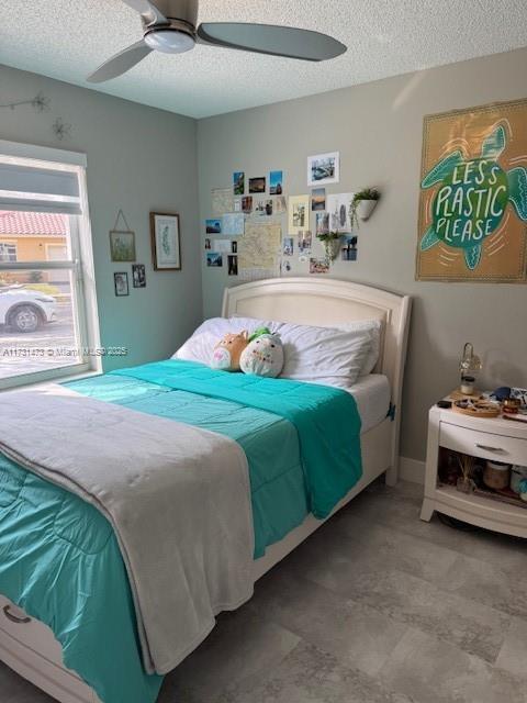 bedroom featuring a textured ceiling and ceiling fan