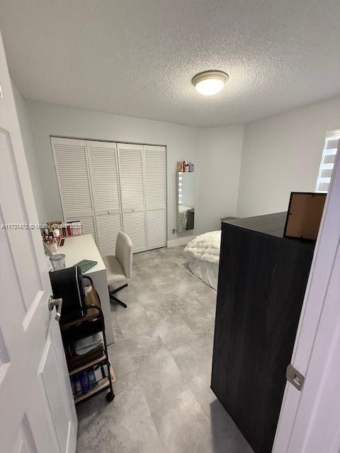 bedroom featuring a closet and a textured ceiling