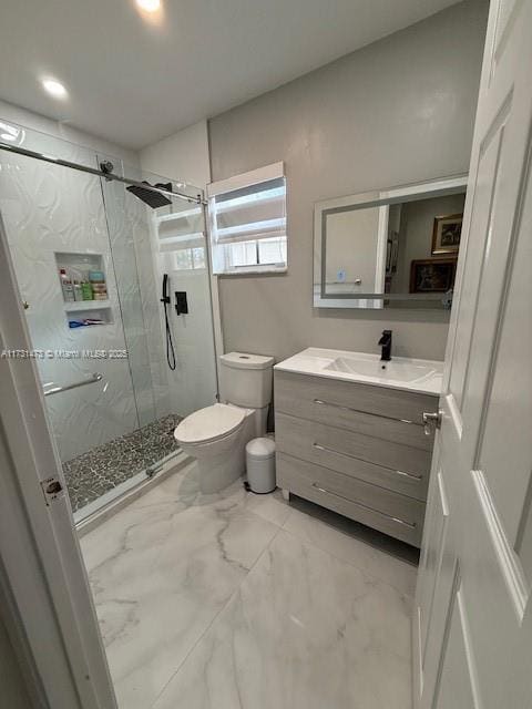 bathroom with vanity, an enclosed shower, and toilet