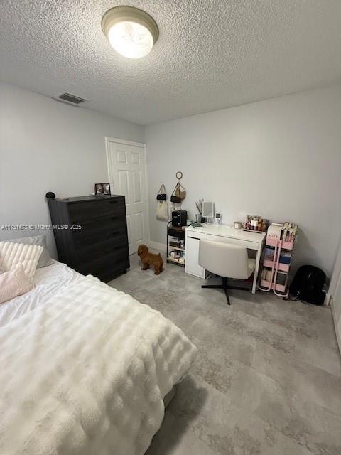 bedroom featuring a textured ceiling