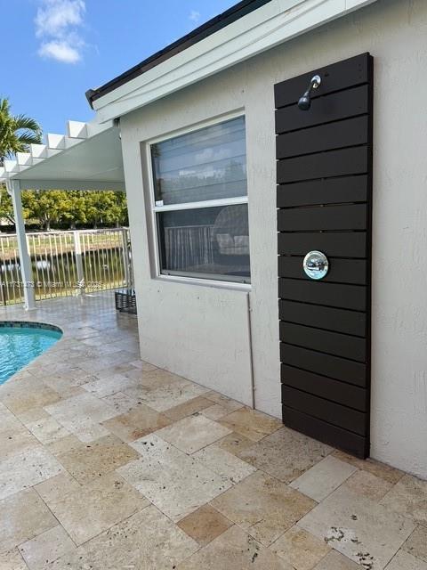 property entrance featuring a patio area